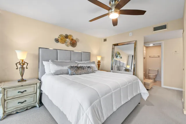 a bathroom with a toilet a sink and a mirror
