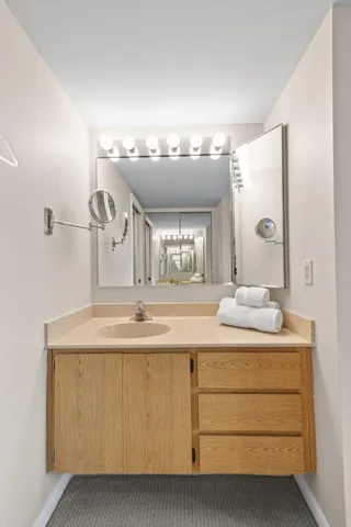 a bedroom with two beds and lamps