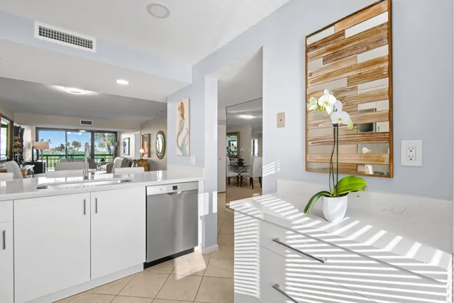 a kitchen with stainless steel appliances kitchen island granite countertop a stove and a sink
