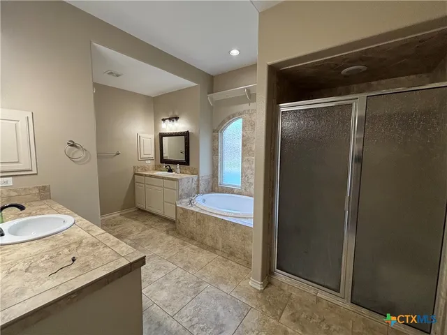a bathroom with a granite countertop sink mirror and shower