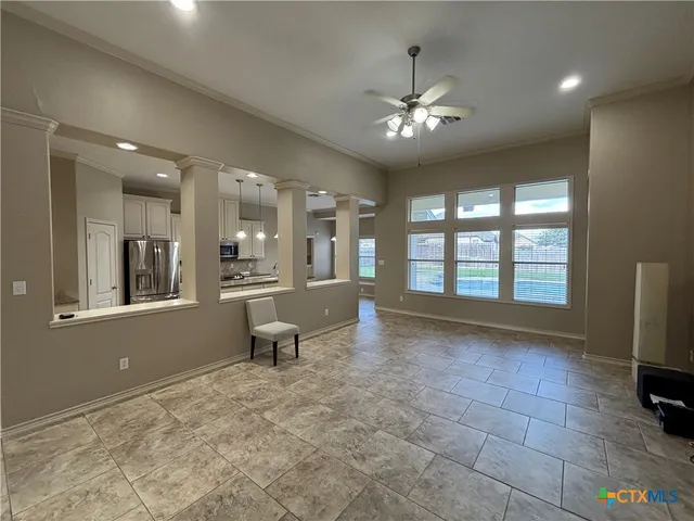 a view of a livingroom with a lounge chair and a large window