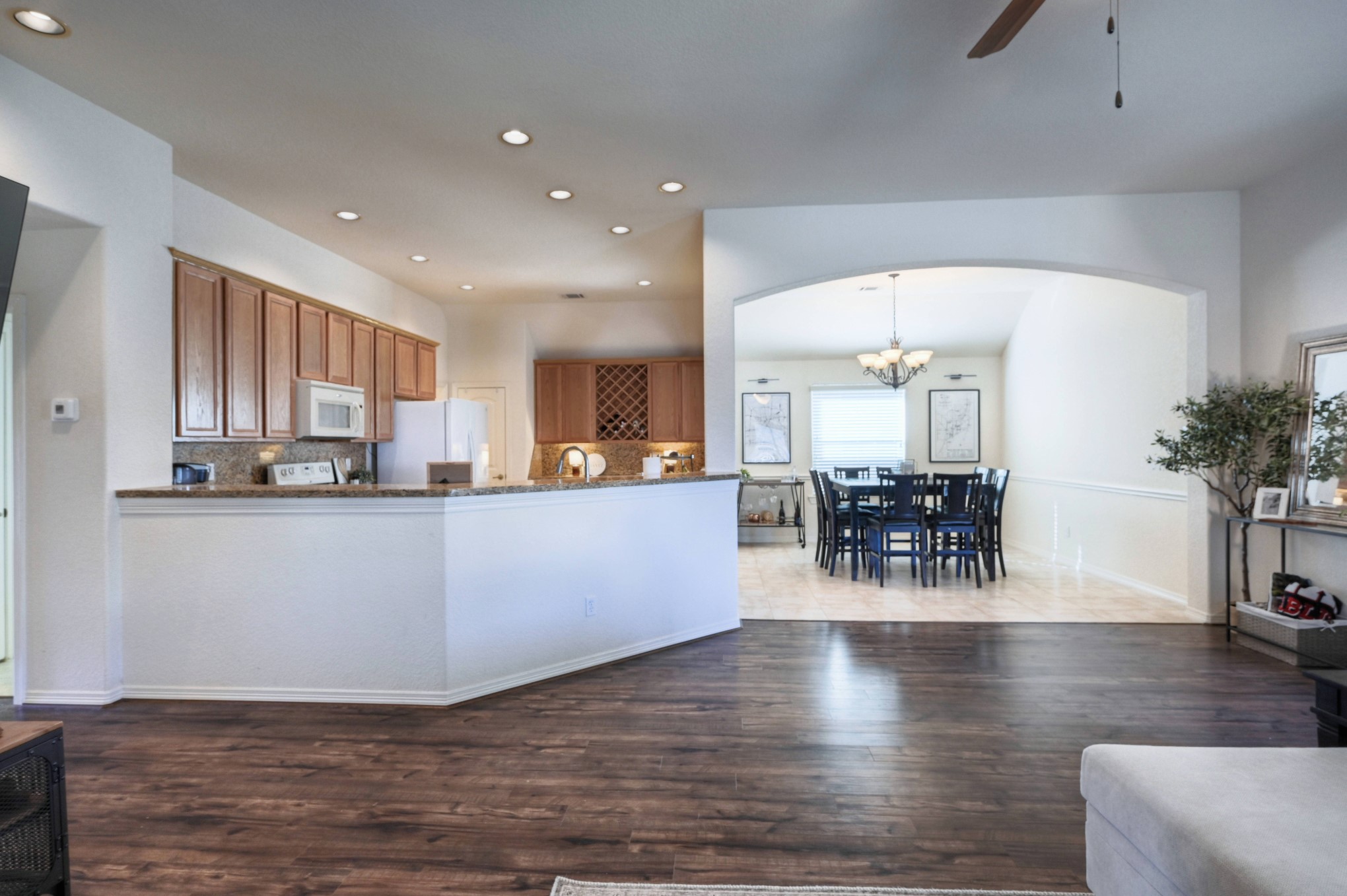 108 Cove Circle Conroe, TX 77356 - Photo 14 of 50 Indulge in the sense of openness as you gaze from the living room into the expansive, open-concept kitchen and dining areas, showcased in this photo. This is very unique to other homes this size in April Sound. The seamless flow between these spacious zones promises a harmonious blend of shared meals, and comfortable living, making it the heart of the home.