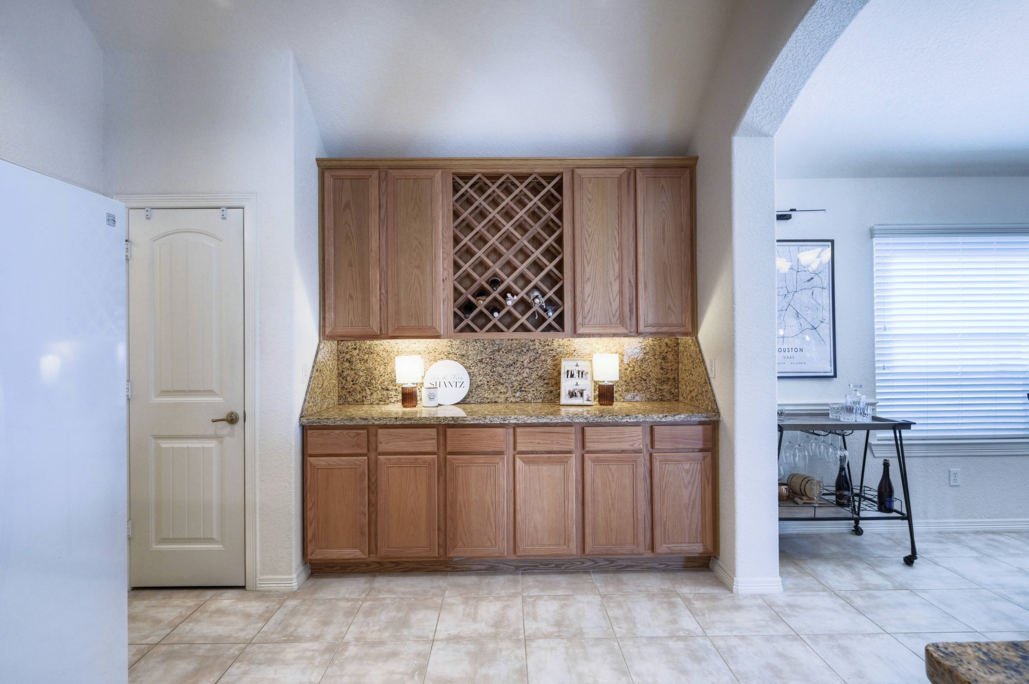 108 Cove Circle Conroe, TX 77356 - Photo 21 of 50 Reveal the character of the kitchen's serving bar in this photo, complete with a handy wine storage feature. This practical touch adds both functionality and a touch of style, creating an ideal space for hosting and storing your favorite wines.
