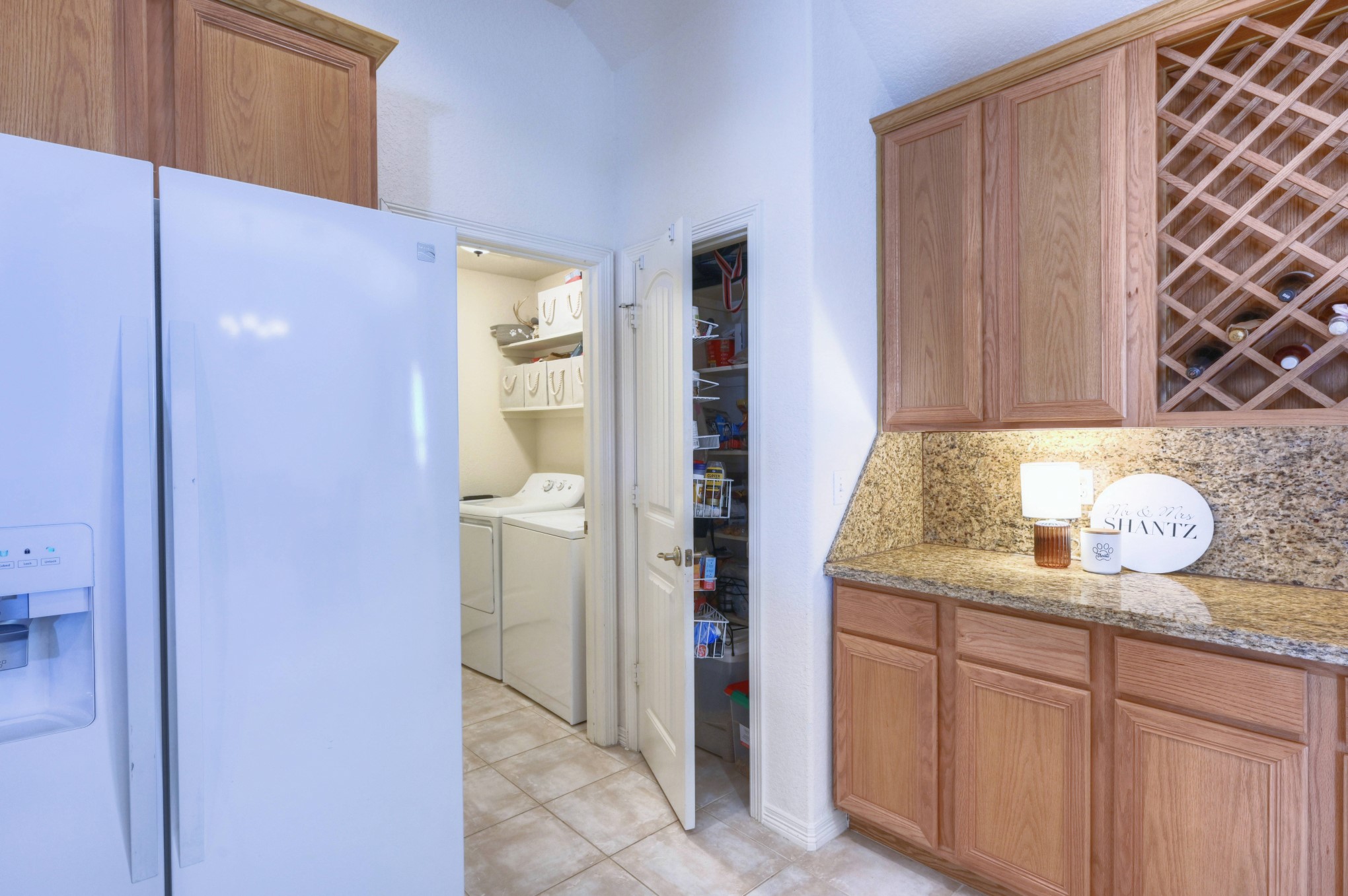 108 Cove Circle Conroe, TX 77356 - Photo 22 of 50 Explore the kitchen's functionality in this photo, where to the left of the serving bar, a convenient pantry closet awaits. This thoughtful addition ensures easy access to essentials, combining practicality with seamless organization for a well-equipped space.