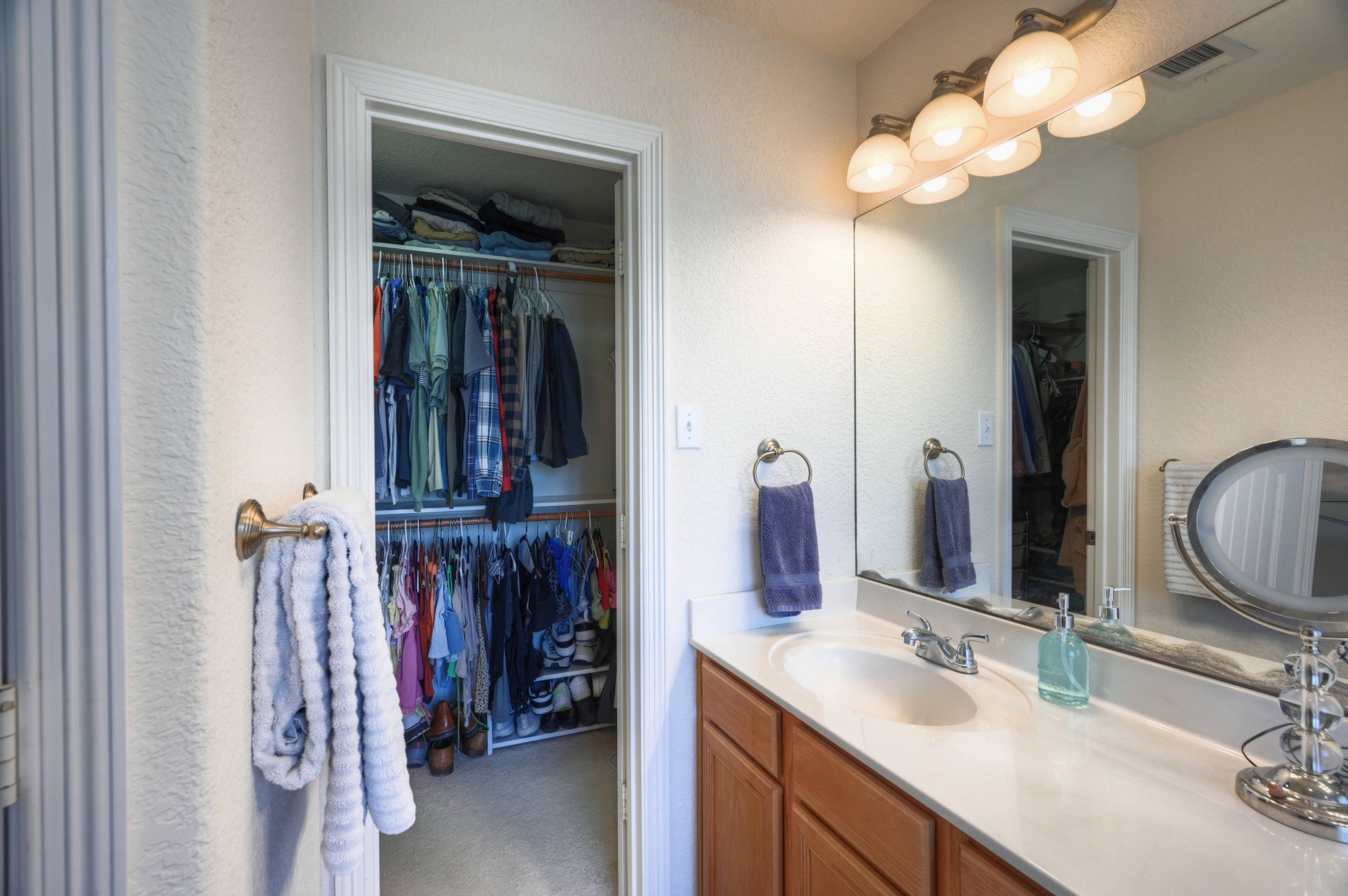 108 Cove Circle Conroe, TX 77356 - Photo 28 of 50 Explore convenience and organization in this photo unveiling the walk-in closet adjacent to the bathroom. This thoughtfully designed space offers ample storage for your wardrobe, creating an efficient and stylish extension of the primary suite.