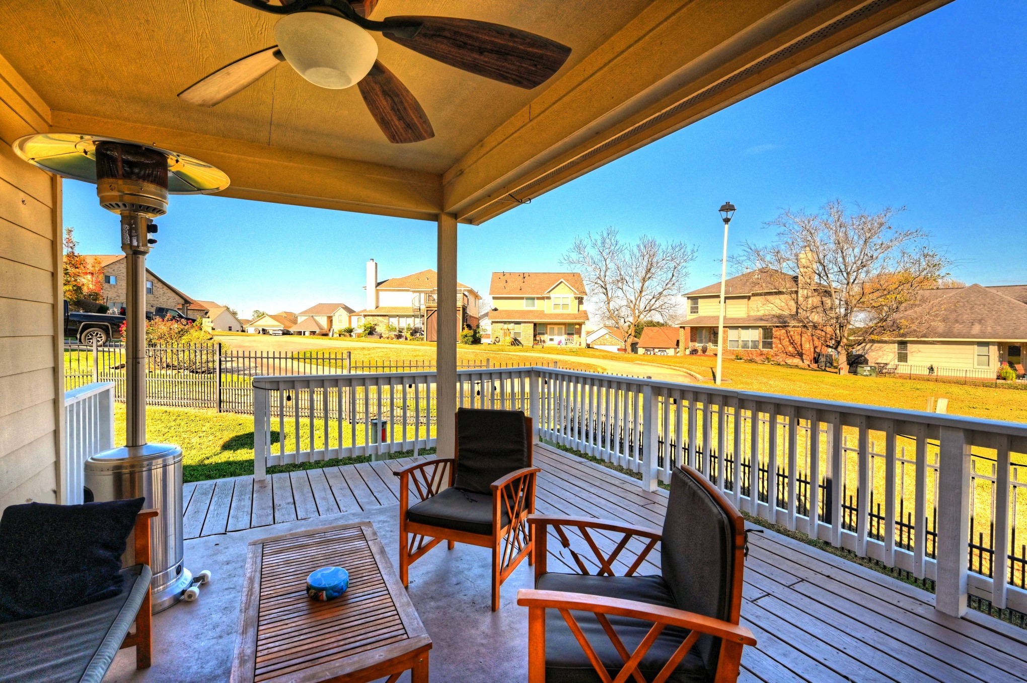 108 Cove Circle Conroe, TX 77356 - Photo 33 of 50 Escape to comfort on the back covered patio, as captured in this photo, featuring a ceiling fan to offer a cool respite from the Texas heat. This outdoor haven invites you to unwind in shade and style, providing the perfect setting for al fresco gatherings and relaxation.