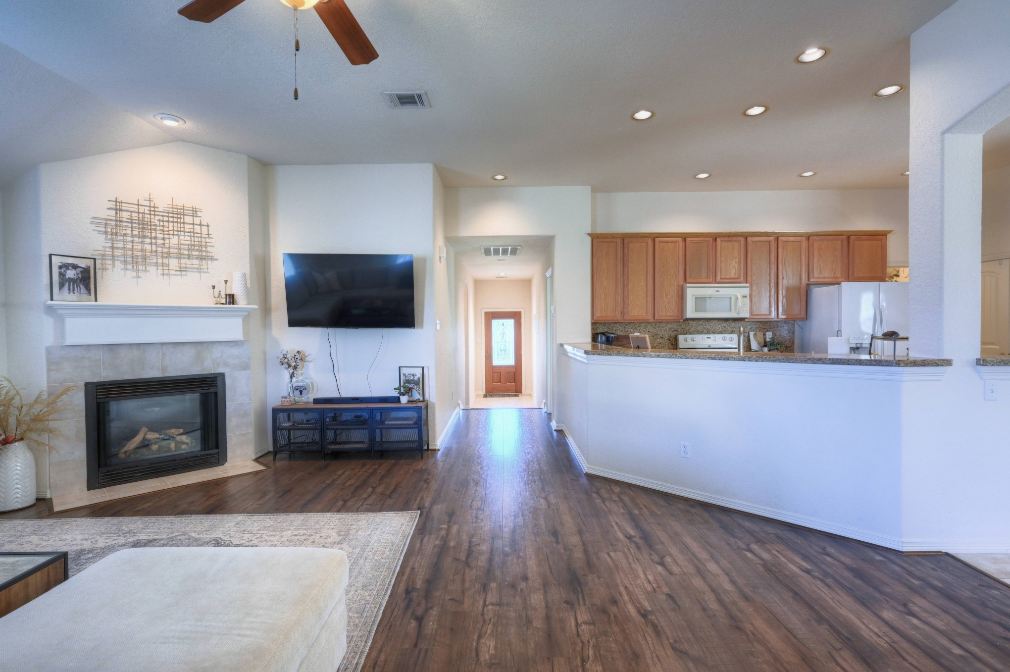 108 Cove Circle Conroe, TX 77356 - Photo 40 of 50 Capture the interconnected design of the home in this photo, revealing a view from the back that seamlessly extends to the front hallway. The inviting sight guides you back towards the secondary bedrooms and bathroom, creating a harmonious flow that enhances the sense of space and connectivity throughout the residence.