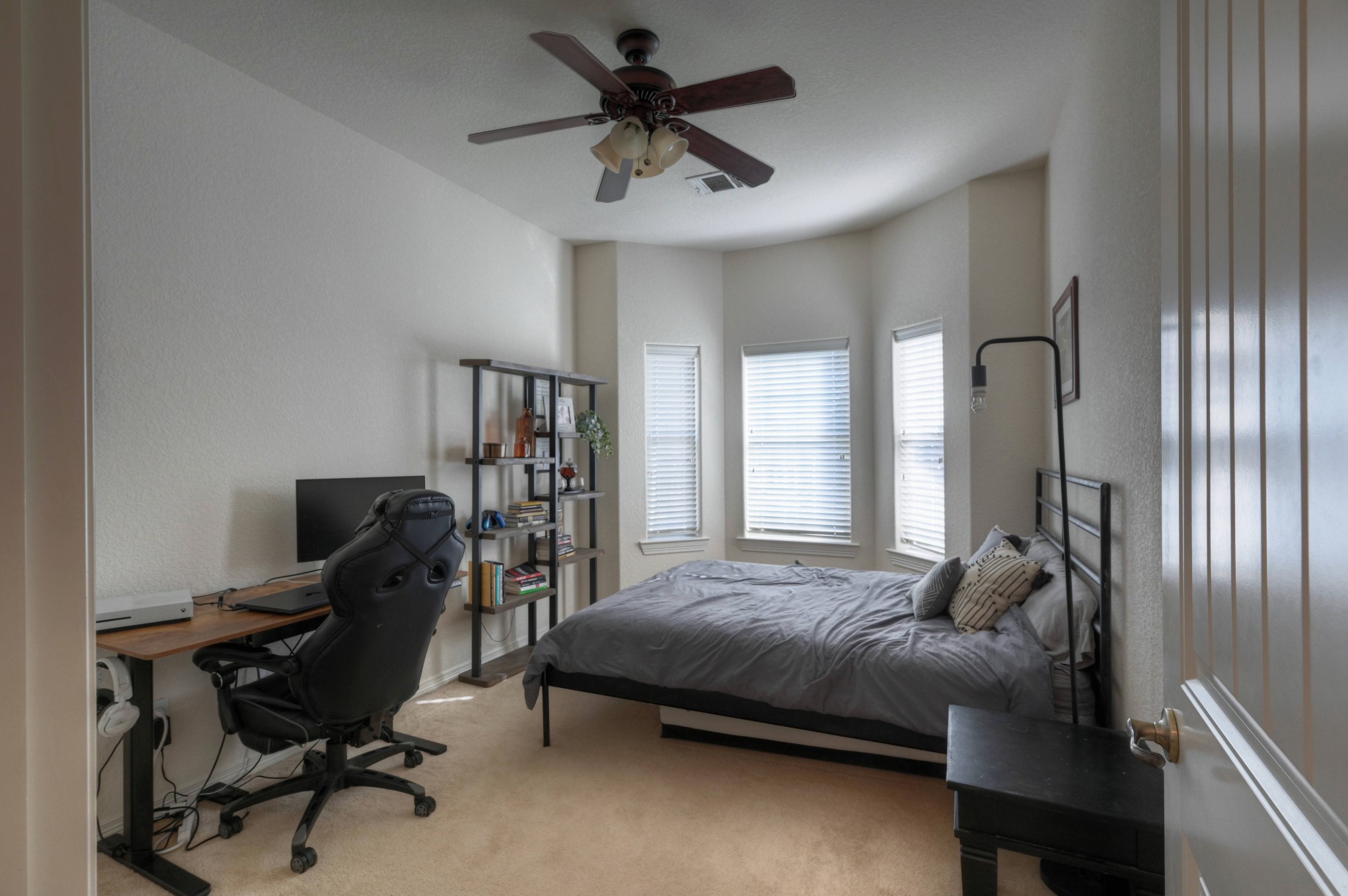 108 Cove Circle Conroe, TX 77356 - Photo 44 of 50 Bask in the spaciousness and natural light of the other secondary bedroom, as captured in this photo. This inviting space showcases ample room for comfort, creating a bright and airy retreat that welcomes both relaxation and personalization.