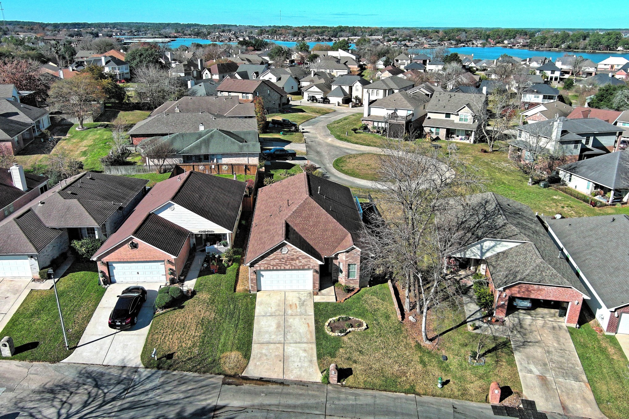 108 Cove Circle Conroe, TX 77356 - Photo 47 of 50 In this aerial view of the home, it's important to mention that the recently installed brand-new heater and water heater, while not pictured, are a valuable and present addition to the property. These recent upgrades contribute to the modern comfort and functionality of the residence, enhancing its overall appeal.