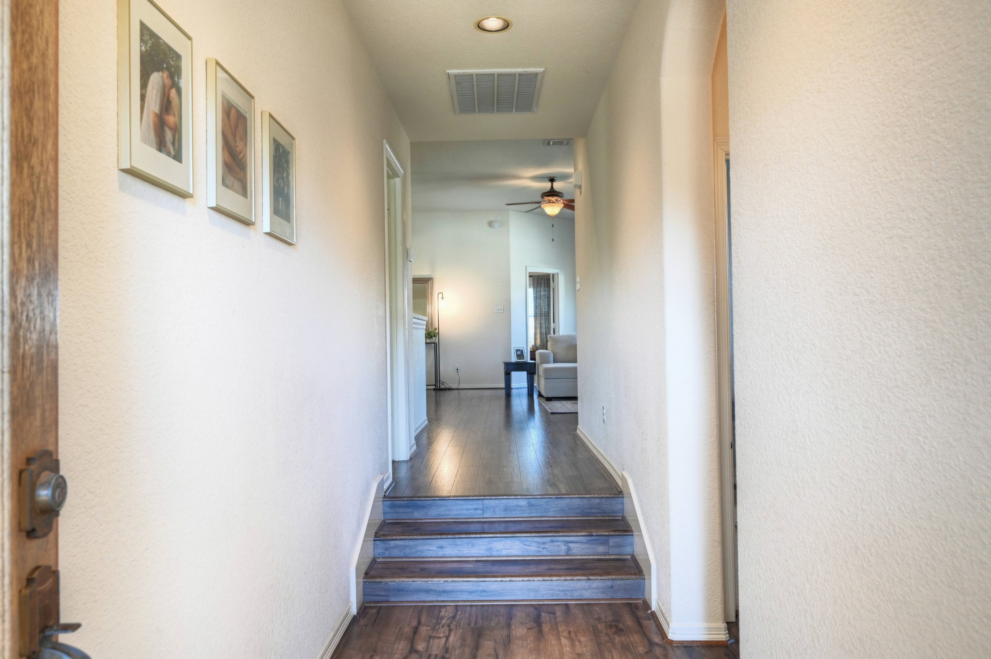 108 Cove Circle Conroe, TX 77356 - Photo 5 of 50 Welcome inside, where you'll be greeted by a laid-back charm as you open the front door. The entryway features sleek wood laminate flooring and a warm glow from the recessed lighting, creating a relaxed and inviting atmosphere from the moment you step inside.