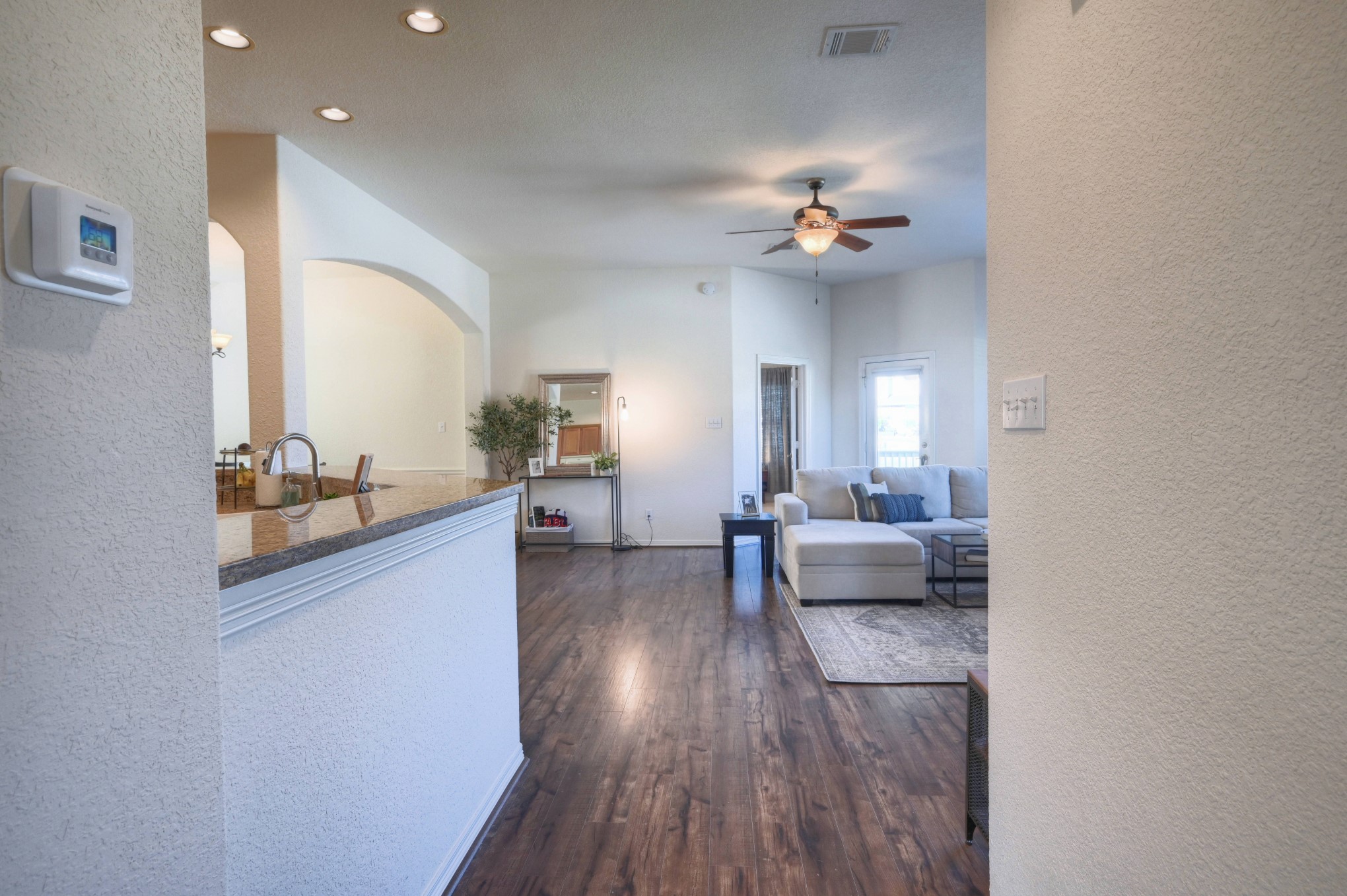 108 Cove Circle Conroe, TX 77356 - Photo 10 of 50 As you step back into the main hallway, a seamless transition unfolds, revealing the inviting main living space captured in this photo.