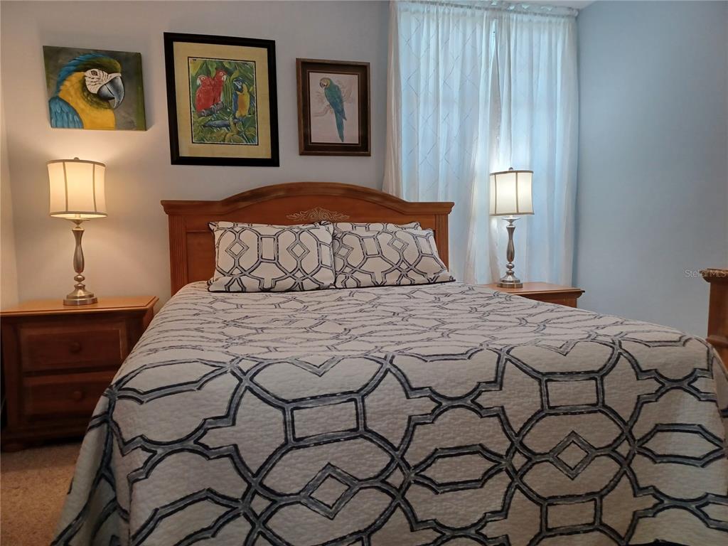 4318 Tahitian Gardens Circle, Unit B Holiday, FL 34691 - Photo 18 of 28 a bedroom with a bed and painting on the wall