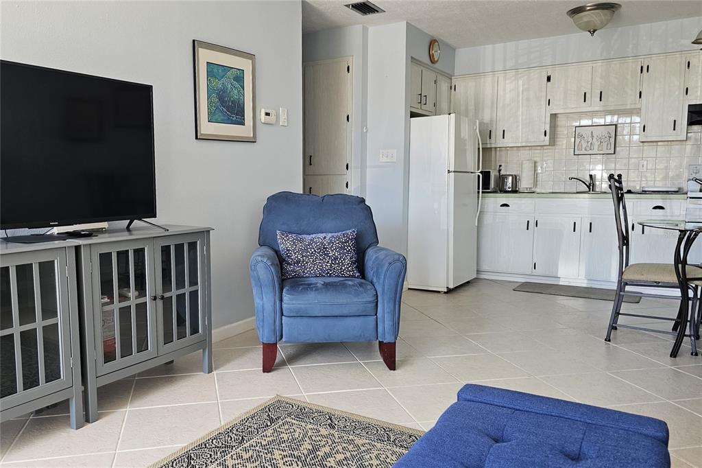 4318 Tahitian Gardens Circle, Unit B Holiday, FL 34691 - Photo 5 of 28 a living room with furniture and a flat screen tv