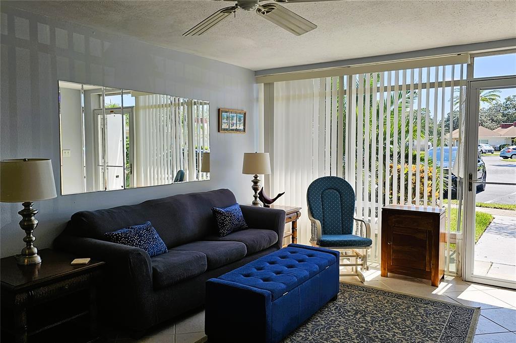 4318 Tahitian Gardens Circle, Unit B Holiday, FL 34691 - Photo 7 of 28 a living room with furniture and a fireplace