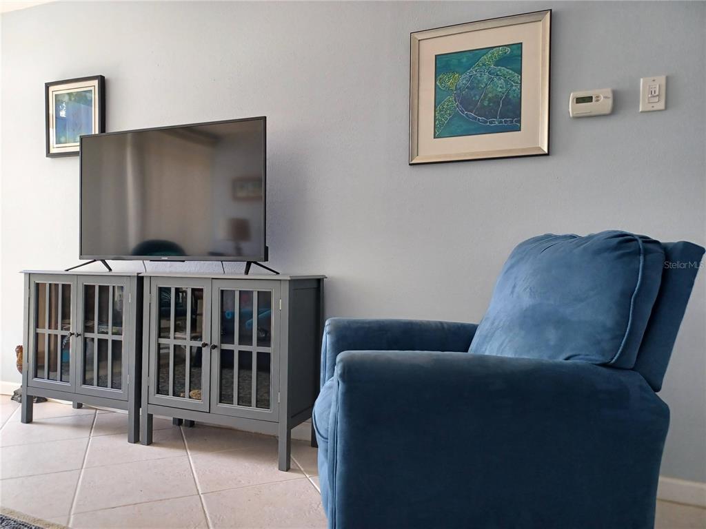 4318 Tahitian Gardens Circle, Unit B Holiday, FL 34691 - Photo 9 of 28 a living room with furniture and a flat screen tv