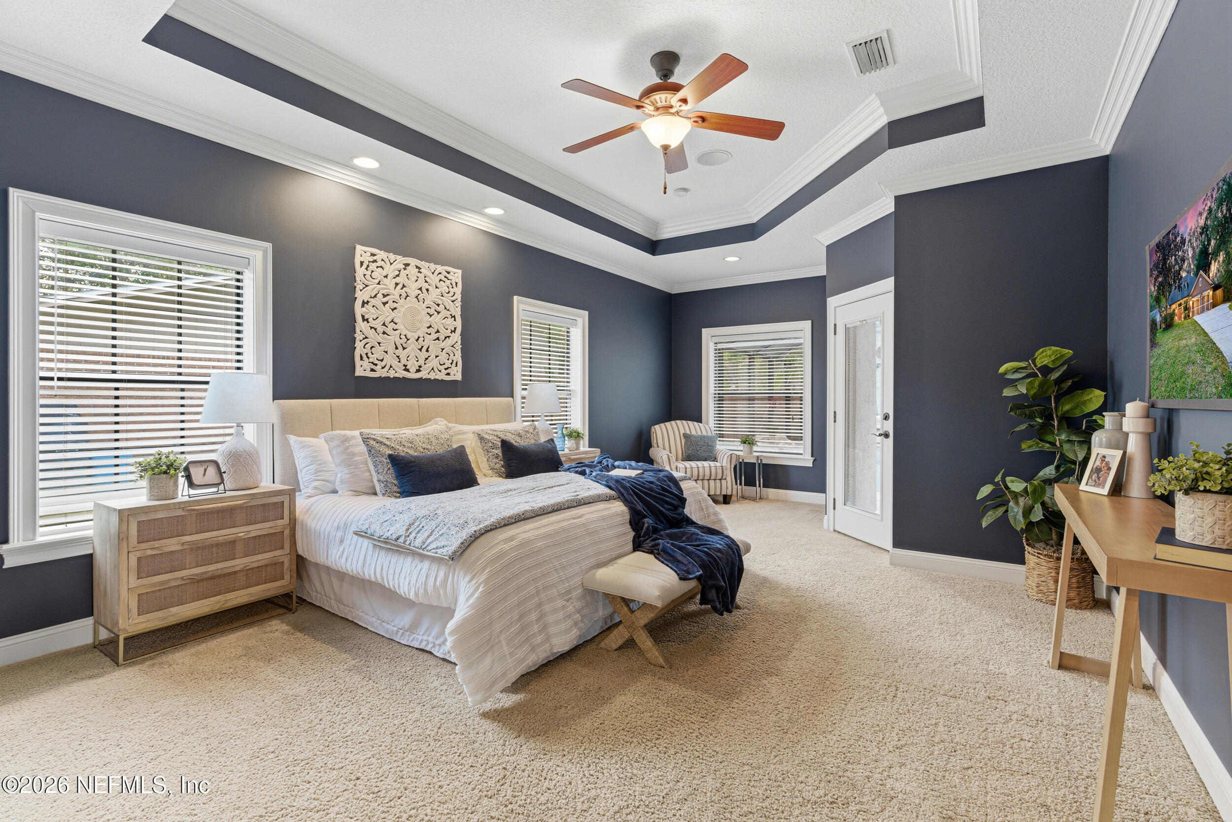 114 Warren Circle St. Johns, FL 32259 - Photo 15 of 32 a spacious bedroom with a bed and a chandelier