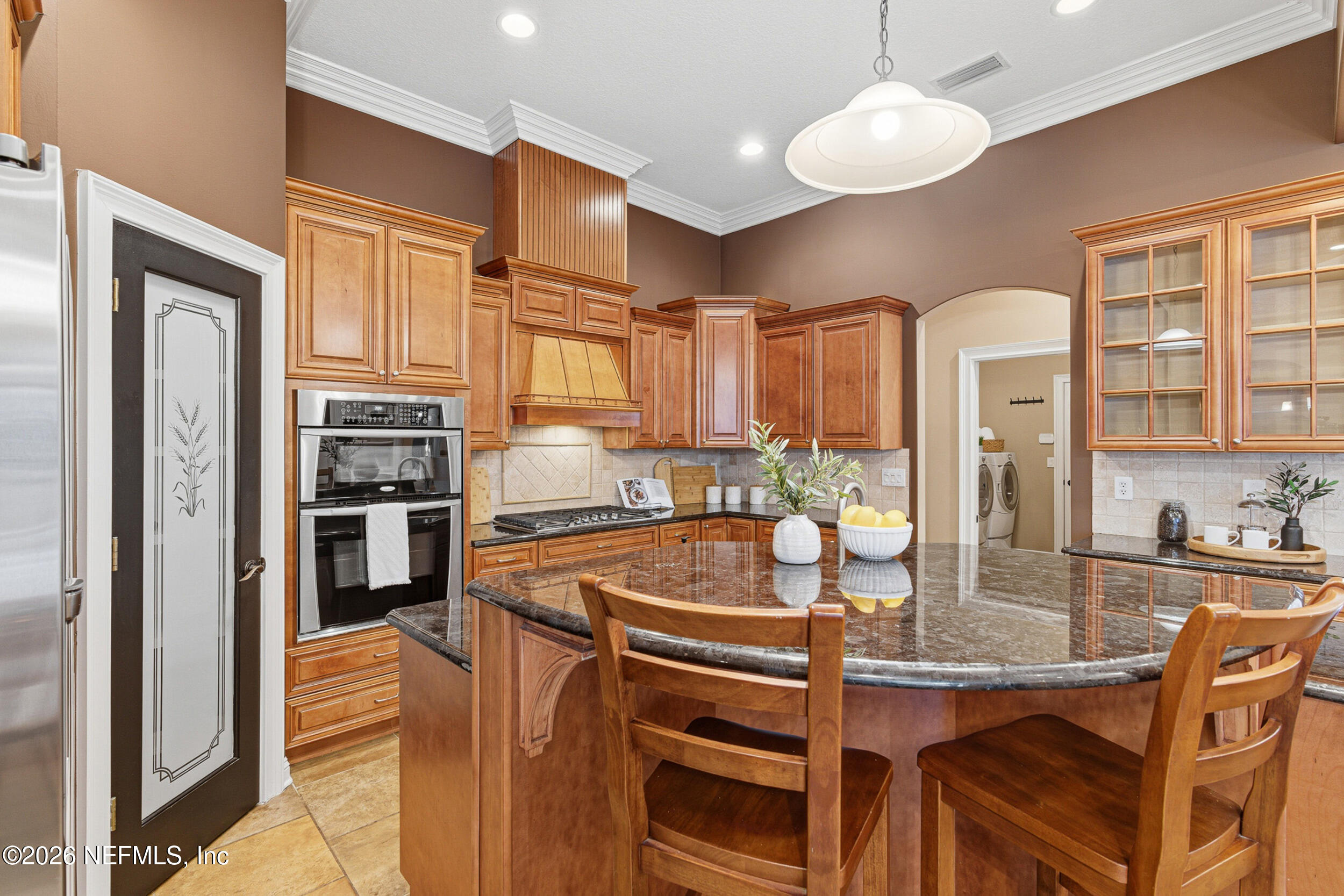 114 Warren Circle St. Johns, FL 32259 - Photo 5 of 32 a kitchen with stainless steel appliances granite countertop a stove refrigerator and cabinets