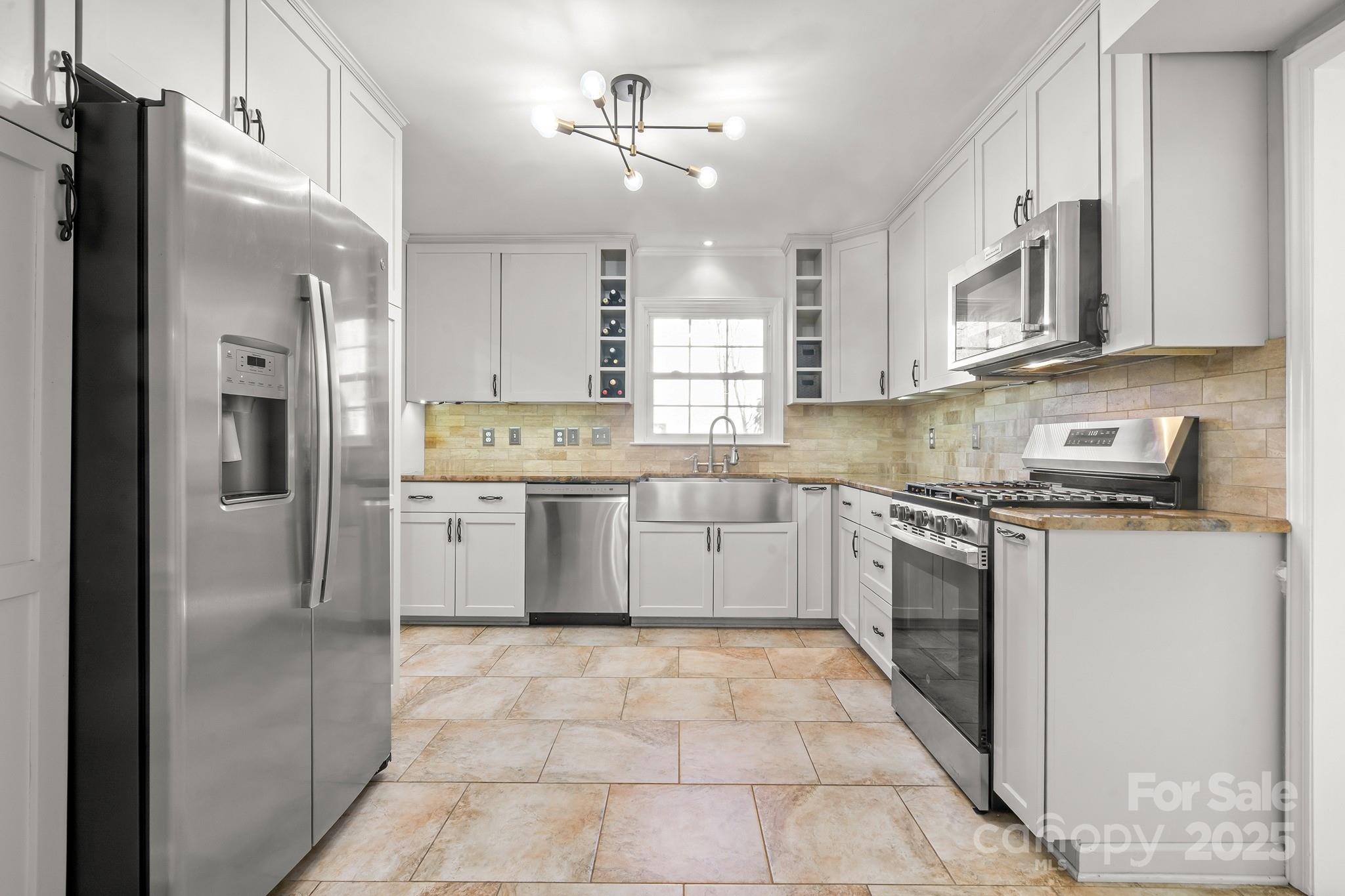 9211 Joyce Kilmer Drive Charlotte, NC 28213 - Photo 11 of 38 a kitchen with stainless steel appliances granite countertop a refrigerator a sink dishwasher a stove with wooden cabinets and floor