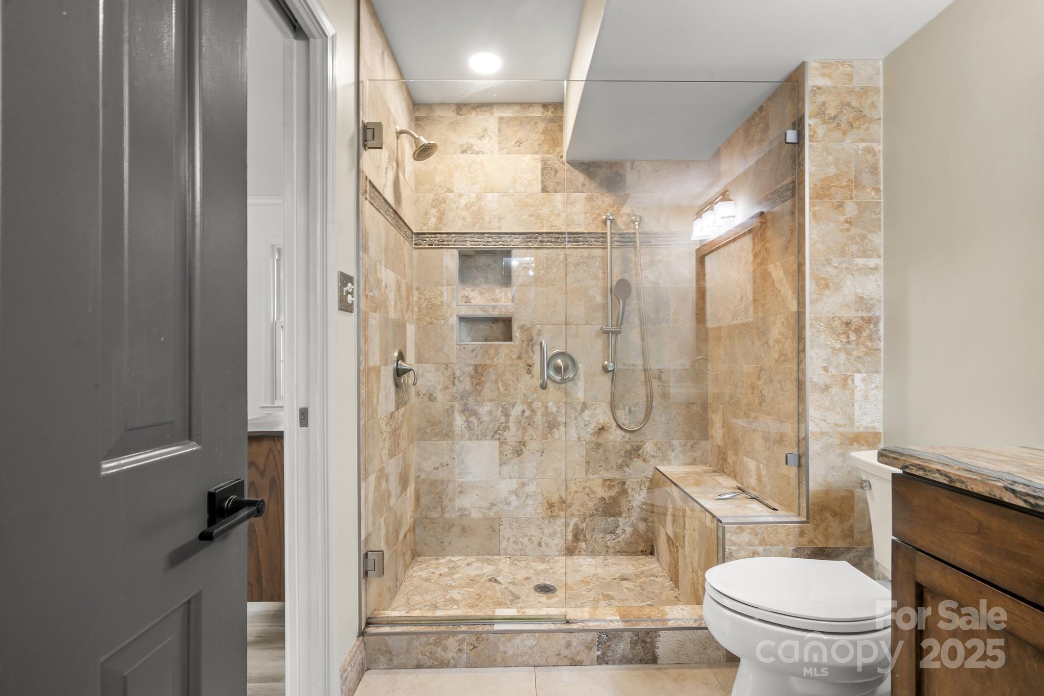 9211 Joyce Kilmer Drive Charlotte, NC 28213 - Photo 17 of 38 a bathroom with a glass shower door