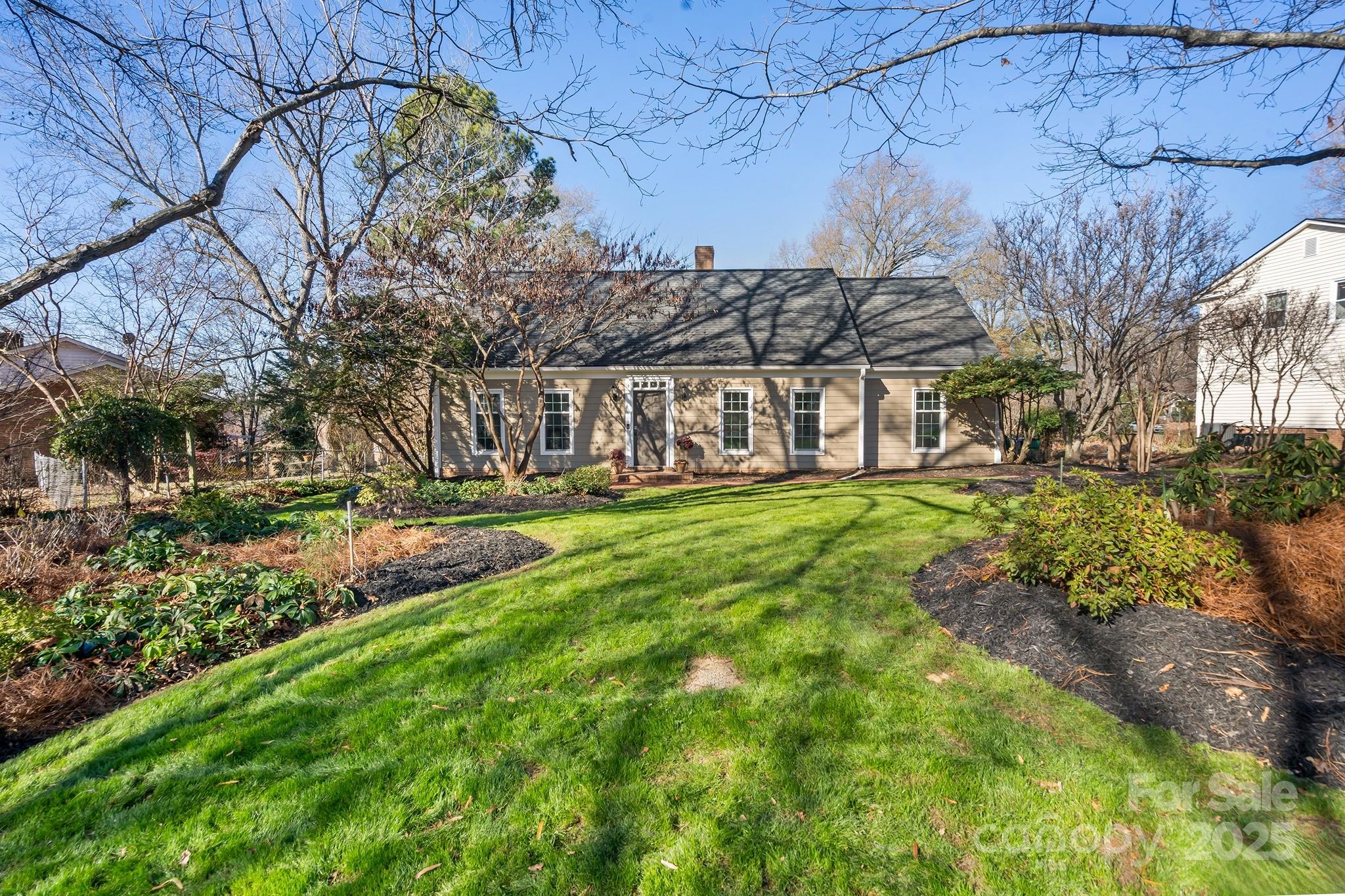 9211 Joyce Kilmer Drive Charlotte, NC 28213 - Photo 2 of 38 a view of a yard with plants and large trees