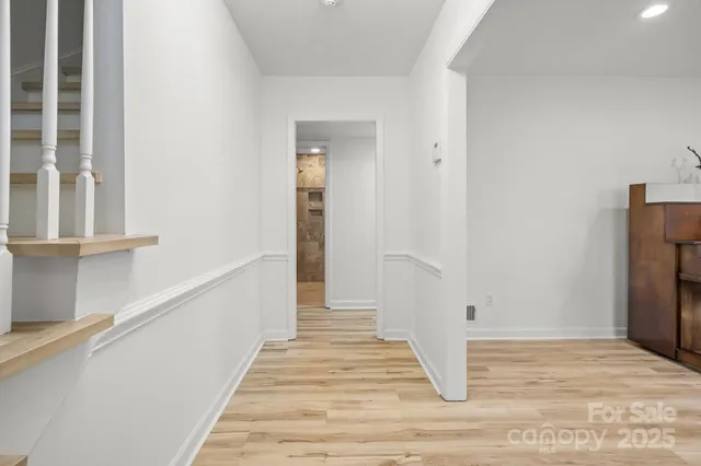 a view of a room with wooden floor and staircase