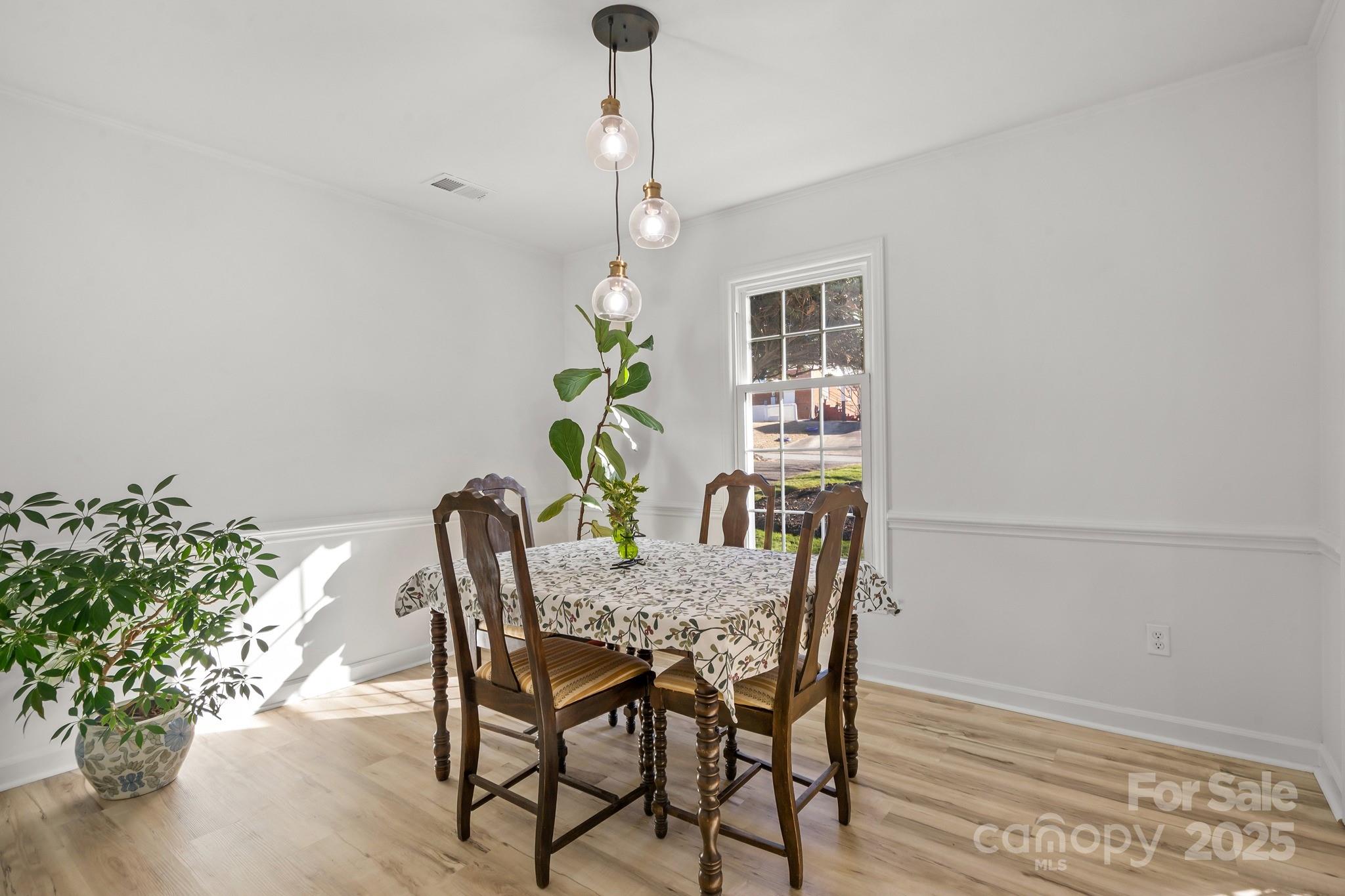 9211 Joyce Kilmer Drive Charlotte, NC 28213 - Photo 10 of 38 a view of a dining room with furniture and a potted plant