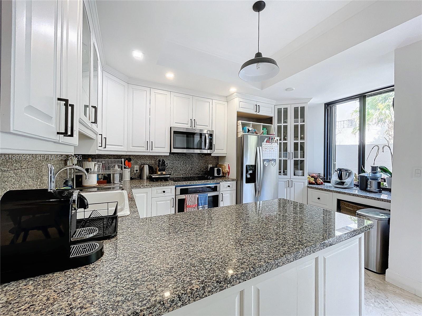 Key Colony Condominiums Key Biscayne, FL 33149 - Photo 12 of 29 a kitchen with stainless steel appliances granite countertop a sink stove and refrigerator