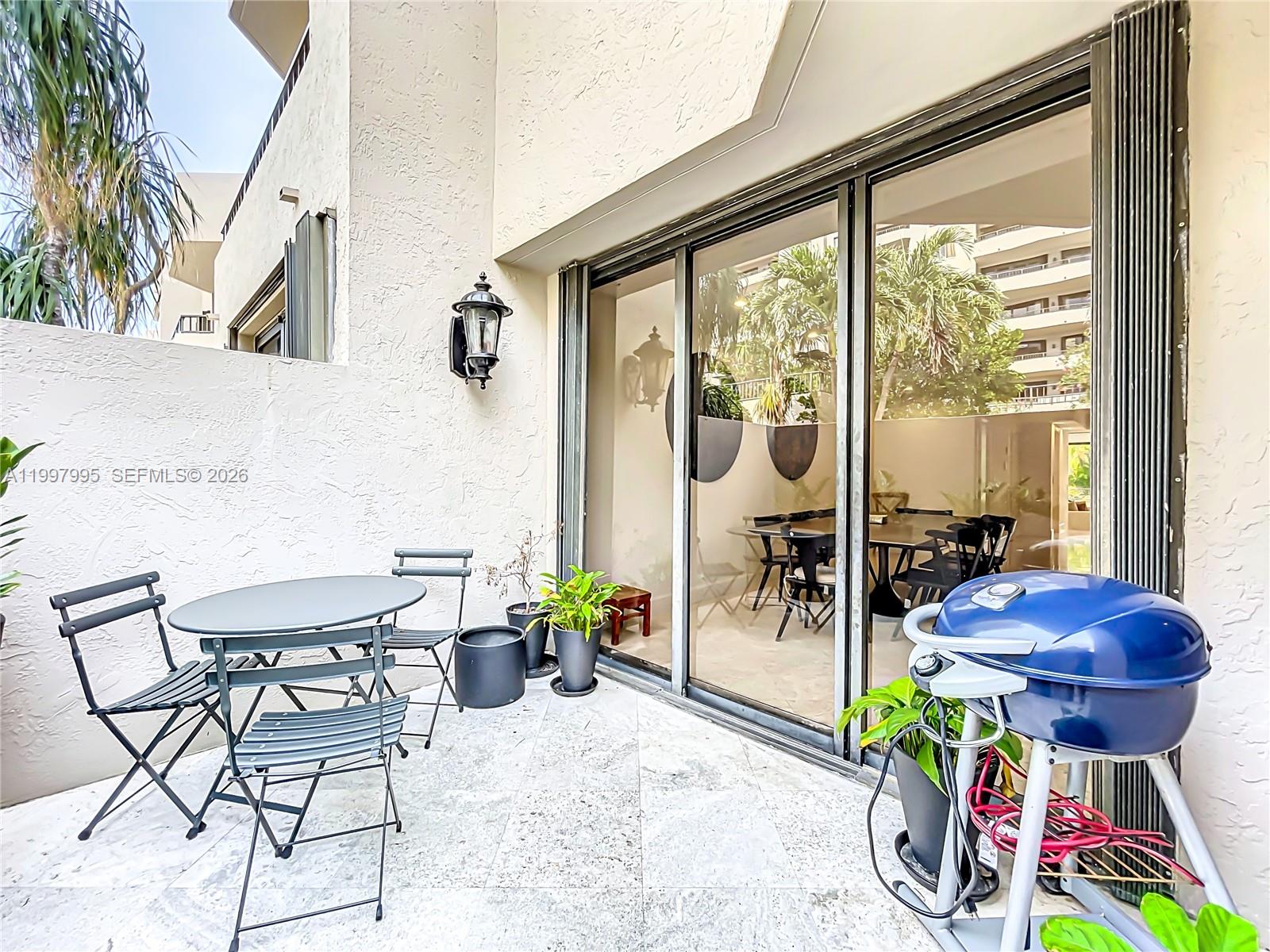 Key Colony Condominiums Key Biscayne, FL 33149 - Photo 14 of 29 a view of a chairs and table in patio