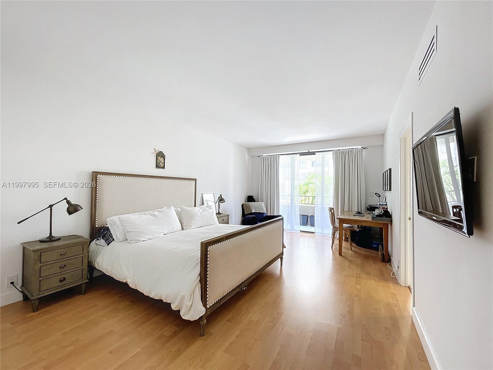 Key Colony Condominiums Key Biscayne, FL 33149 - Photo 16 of 29 a bedroom with a bed and a couch