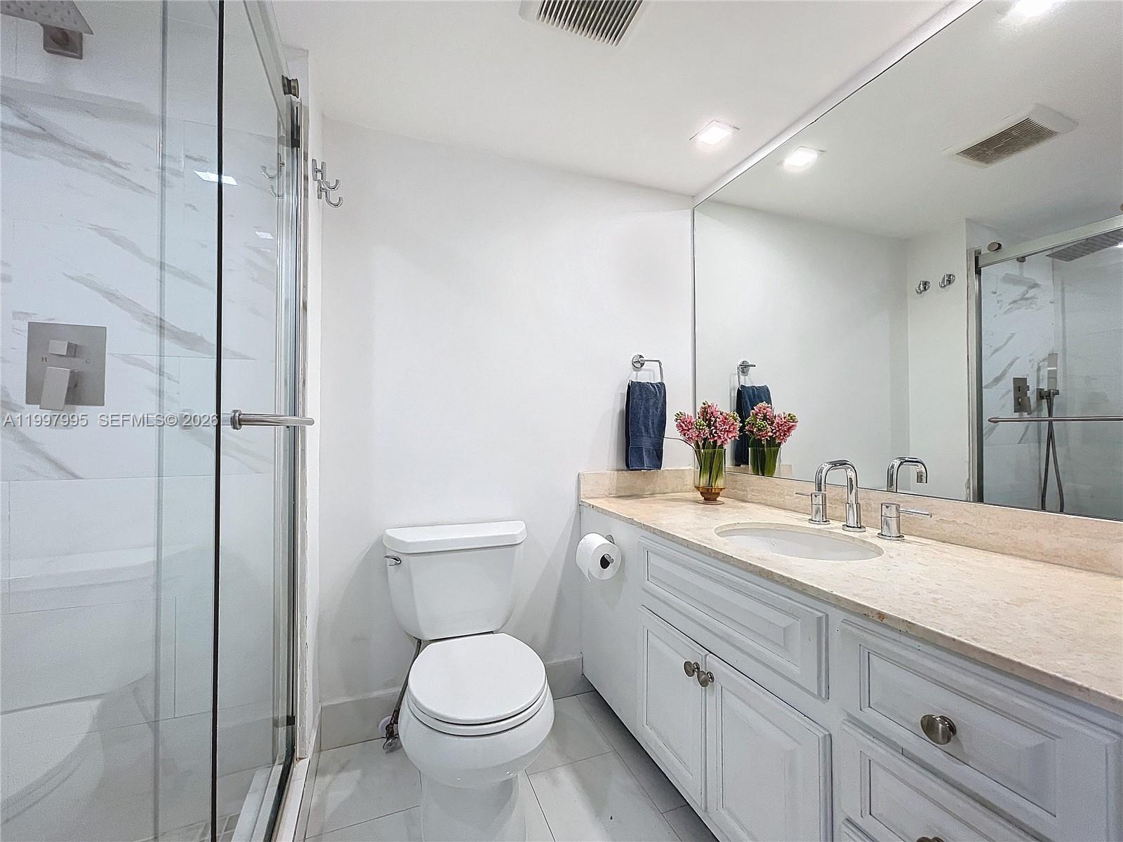 Key Colony Condominiums Key Biscayne, FL 33149 - Photo 23 of 29 a bathroom with a toilet sink and mirror