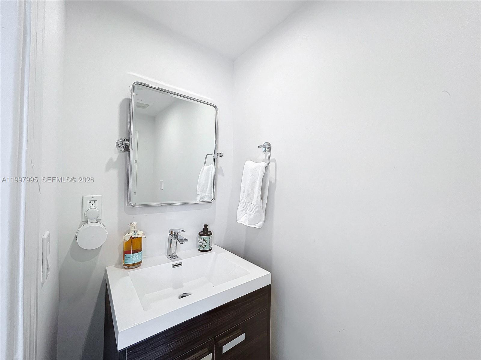 Key Colony Condominiums Key Biscayne, FL 33149 - Photo 27 of 29 a bathroom with a sink and a mirror