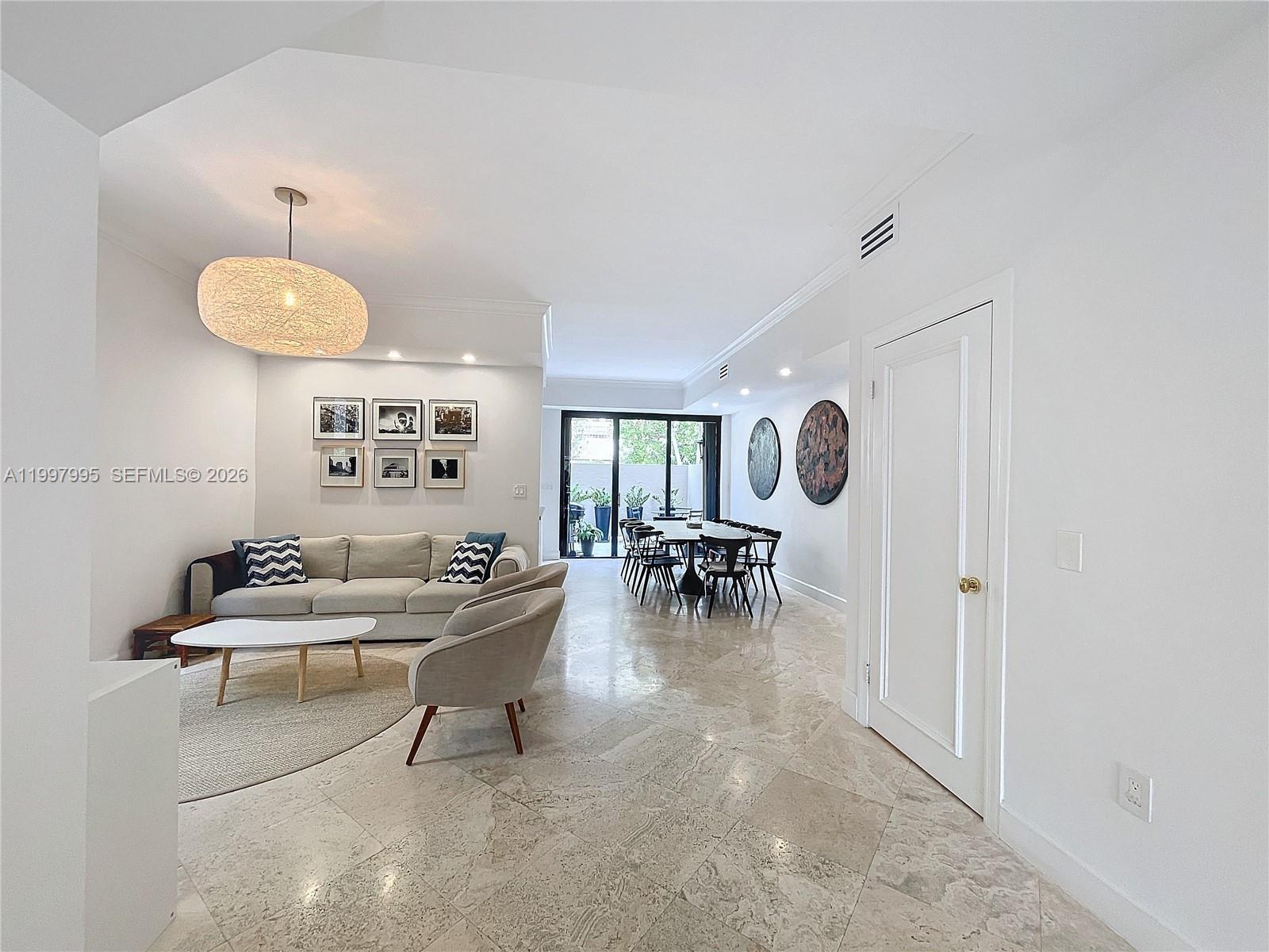 Key Colony Condominiums Key Biscayne, FL 33149 - Photo 10 of 29 a living room with furniture and a chandelier