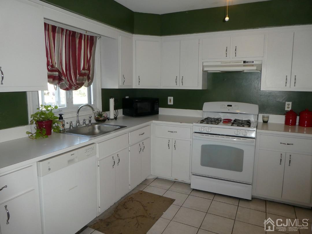 741 Bound Brook Road, Unit 3 Dunellen, NJ 08812 - Photo 2 of 14 a kitchen with cabinets appliances a sink and a counter top