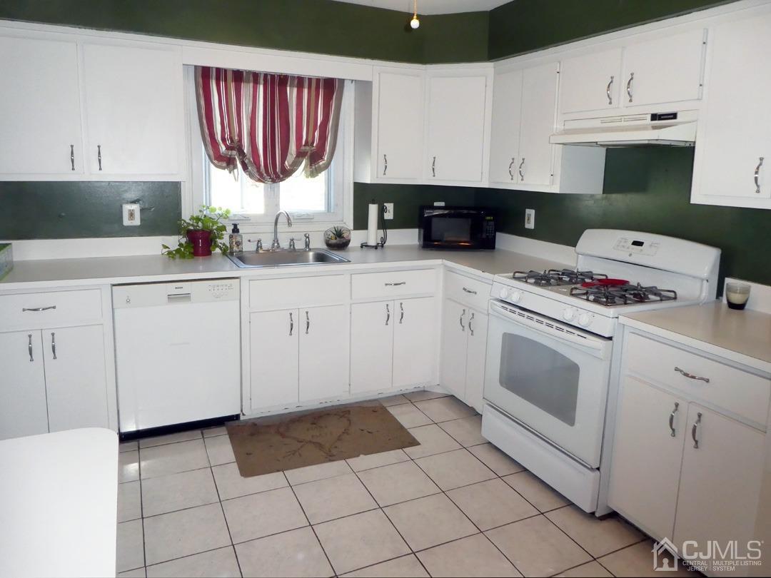 741 Bound Brook Road, Unit 3 Dunellen, NJ 08812 - Photo 3 of 14 a kitchen with cabinets and appliances