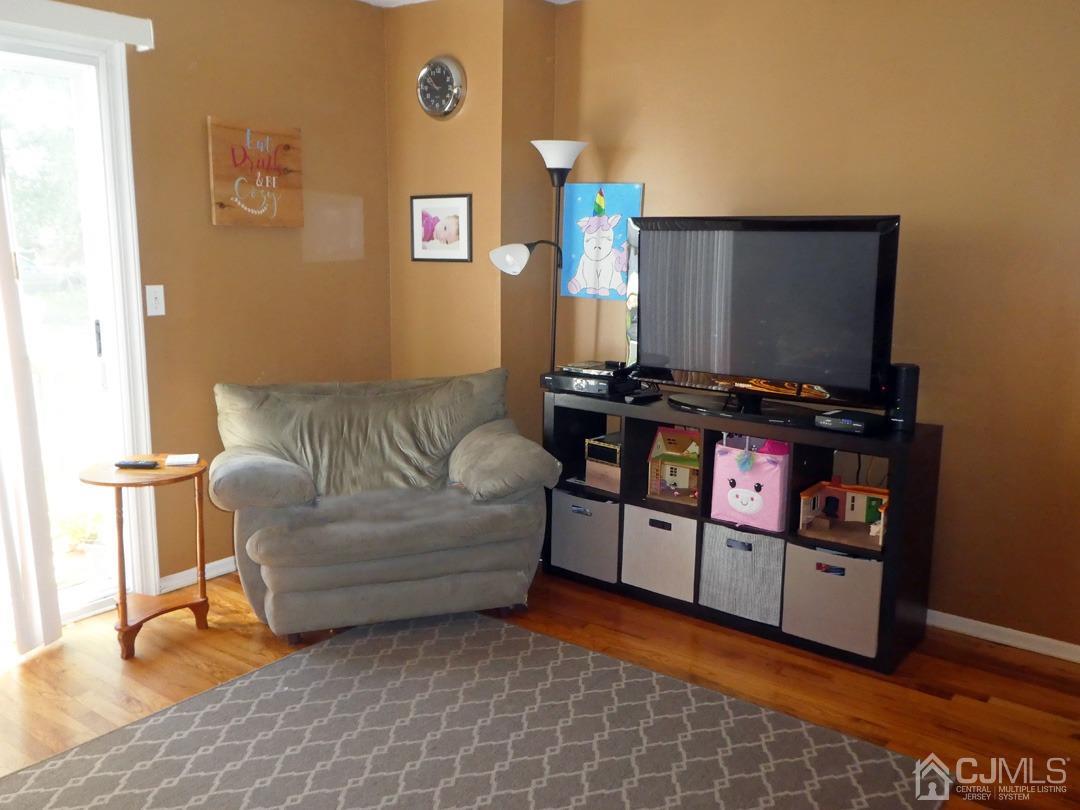 741 Bound Brook Road, Unit 3 Dunellen, NJ 08812 - Photo 6 of 14 a living room with furniture a flat screen tv and a window