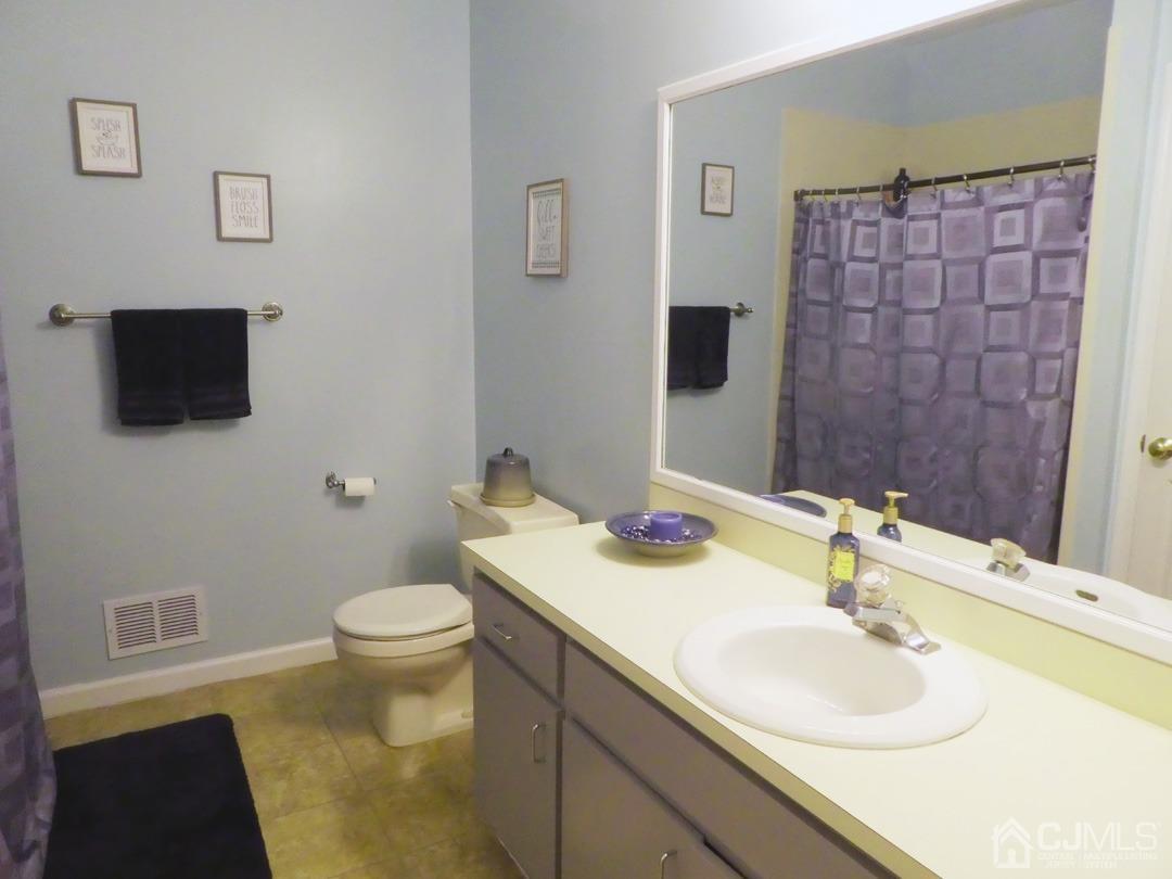741 Bound Brook Road, Unit 3 Dunellen, NJ 08812 - Photo 10 of 14 a bathroom with a sink and a mirror