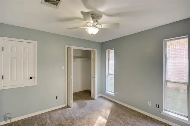 an view of a livingroom with a ceiling fan