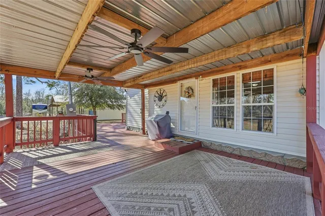 a view of a backyard with wooden floor and iron stairs