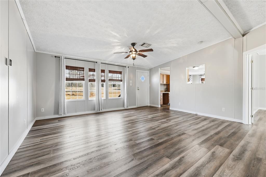 7119 Northeast 24th Loop High Springs, FL 32643 - Photo 11 of 35 a view of an empty room with a window and wooden floor