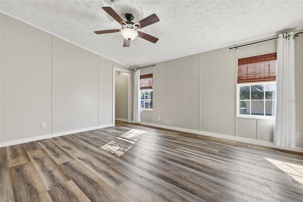 7119 Northeast 24th Loop High Springs, FL 32643 - Photo 14 of 35 a view of an empty room with a window and wooden floor