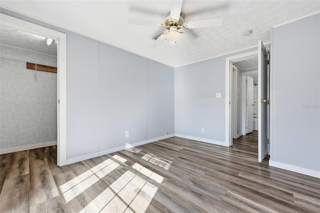 7119 Northeast 24th Loop High Springs, FL 32643 - Photo 19 of 35 wooden floor in an empty room with a window