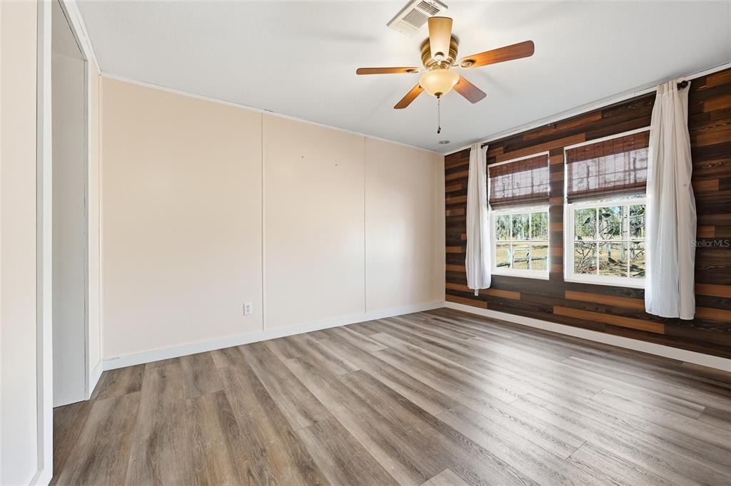 7119 Northeast 24th Loop High Springs, FL 32643 - Photo 21 of 35 wooden floor in an empty room with a window