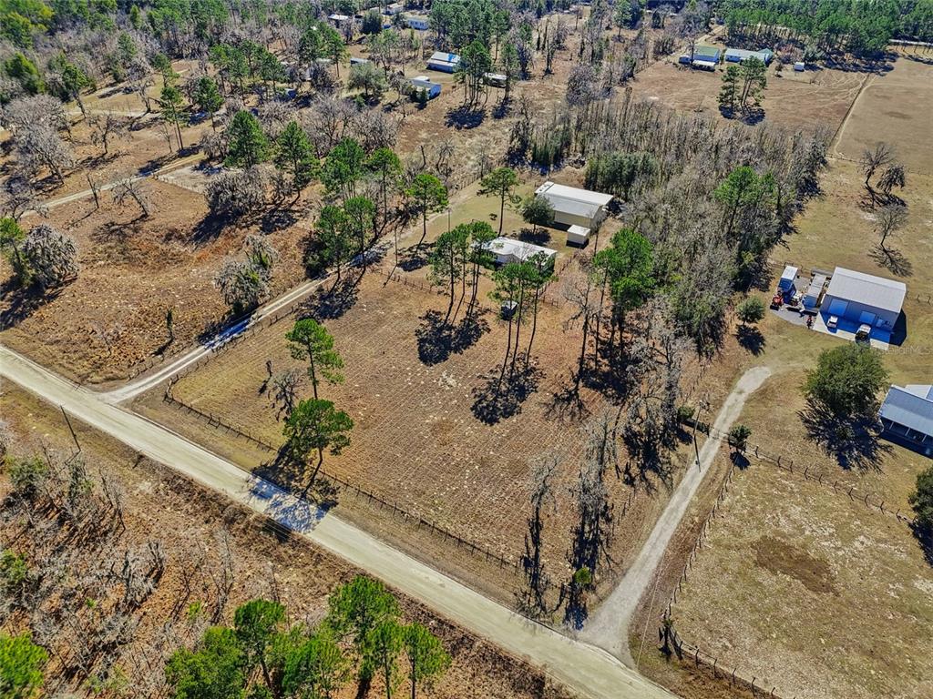 7119 Northeast 24th Loop High Springs, FL 32643 - Photo 34 of 35 an aerial view of a house with a yard and lake view