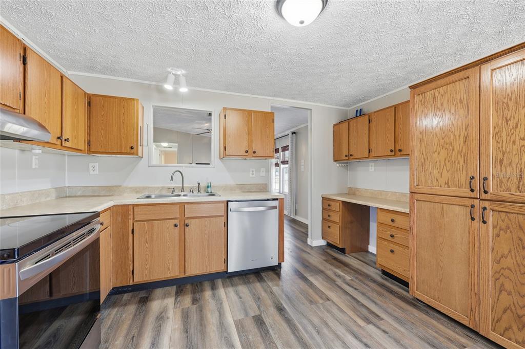 7119 Northeast 24th Loop High Springs, FL 32643 - Photo 7 of 35 a kitchen with a sink stove and cabinets
