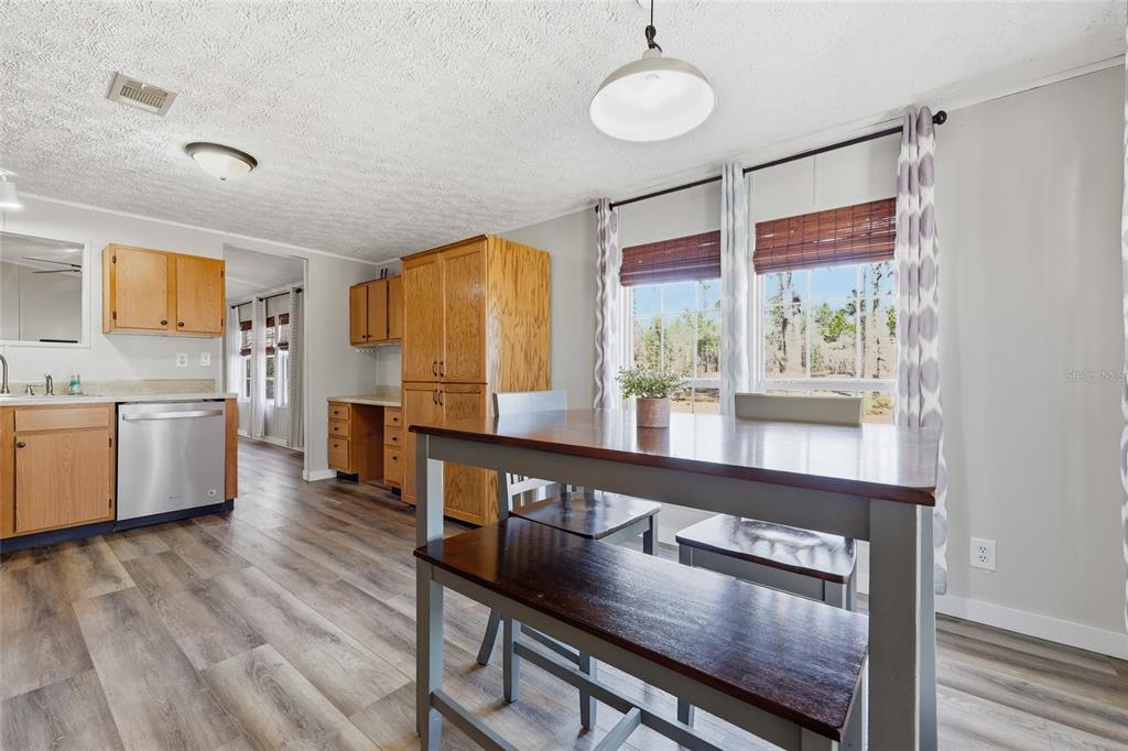 7119 Northeast 24th Loop High Springs, FL 32643 - Photo 9 of 35 a kitchen with stainless steel appliances granite countertop a stove a sink and a refrigerator