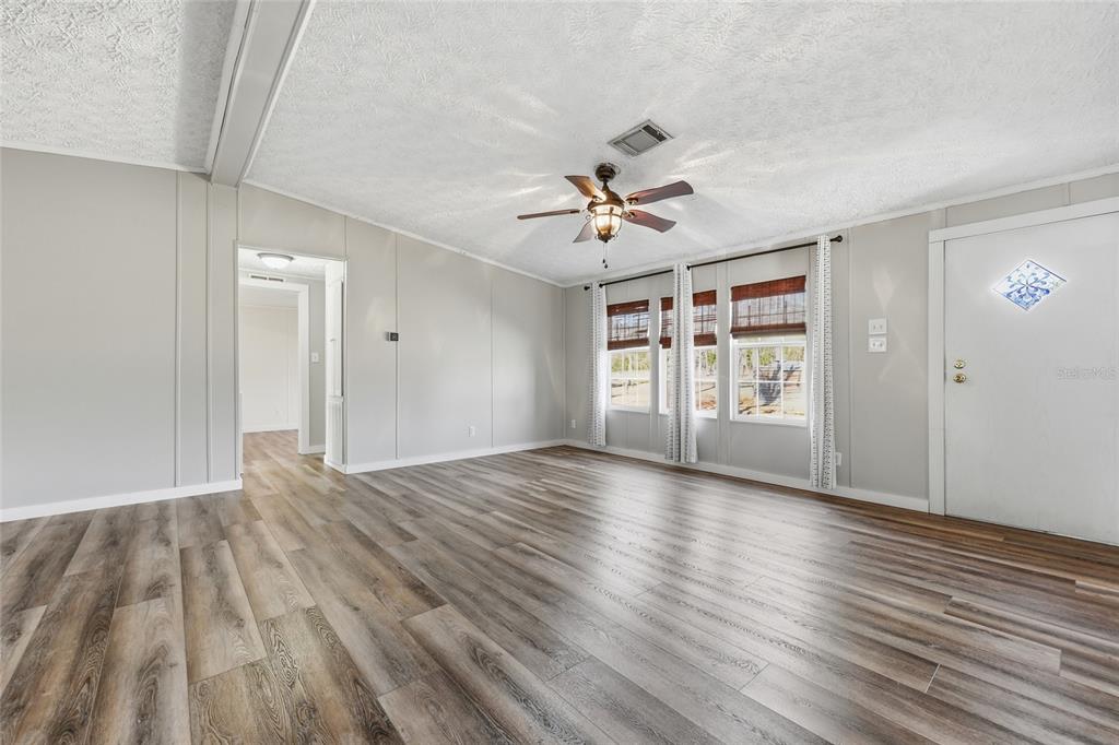 7119 Northeast 24th Loop High Springs, FL 32643 - Photo 10 of 35 a view of an empty room with a window and wooden floor