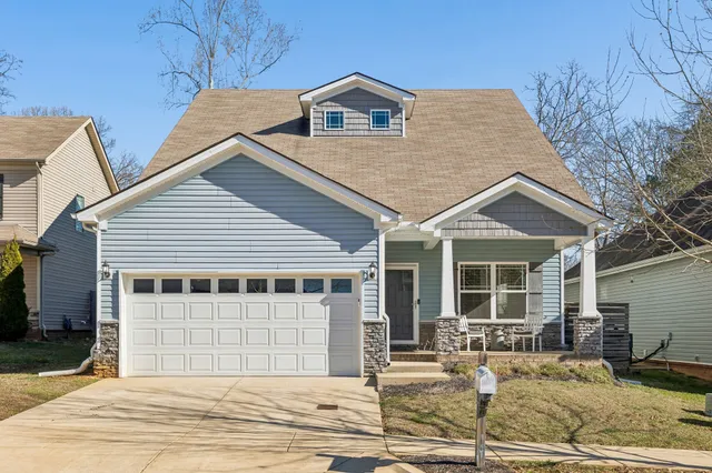 a front view of a house with garage