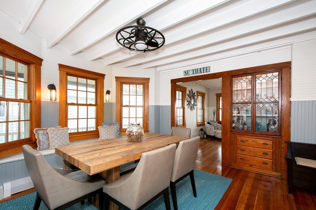 6 Oceanside Drive Scituate, MA 02066 - Photo 11 of 34 a dining room with furniture a chandelier and wooden floor