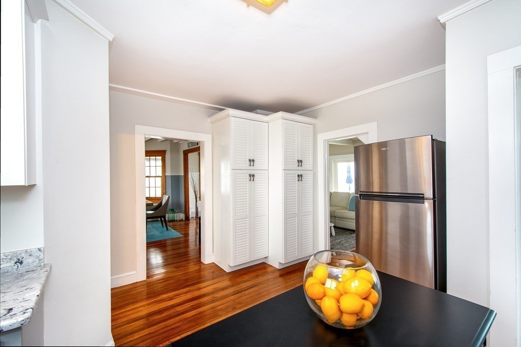 6 Oceanside Drive Scituate, MA 02066 - Photo 13 of 34 a view of a kitchen with wooden floor and a refrigerator