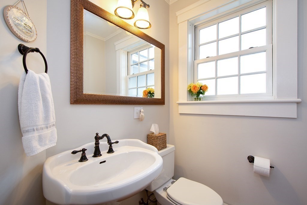 6 Oceanside Drive Scituate, MA 02066 - Photo 16 of 34 a bathroom with a sink mirror and toilet